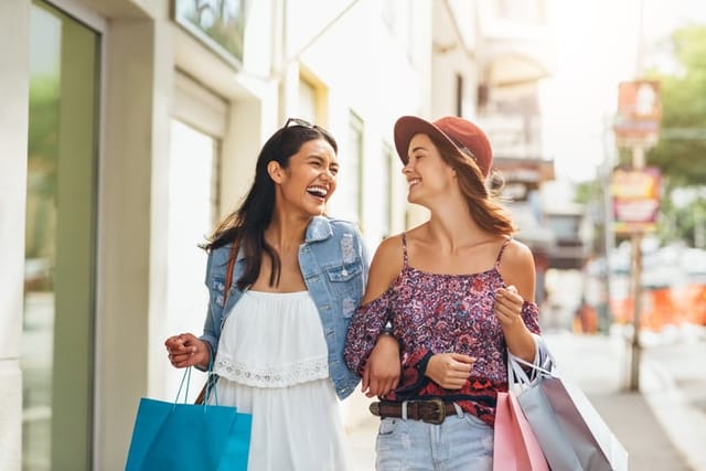 two friends laughing while shopping