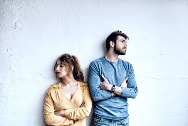 serious young french couple looking pensive in opposite directions