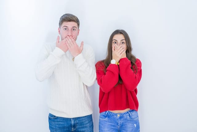 Beautiful young couple over white isolated background shocked covering mouth with hands for mistake. Secret concept.