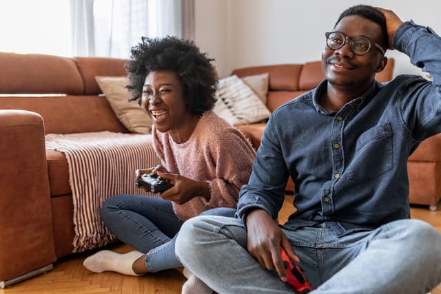 couple playing video games in living room