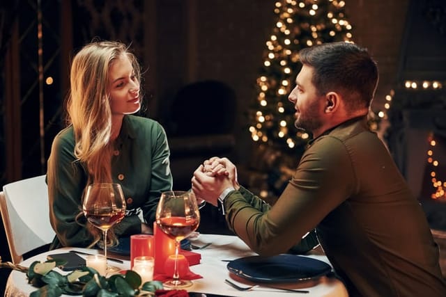 Closeness of the people. Young lovely couple have romantic dinner indoors together.