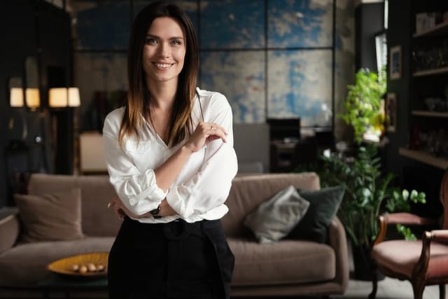 Confident stylish european middle aged woman standing at workplace. Stylish businesswoman, 30s lady executive leader manager looking at camera in office, portrait.