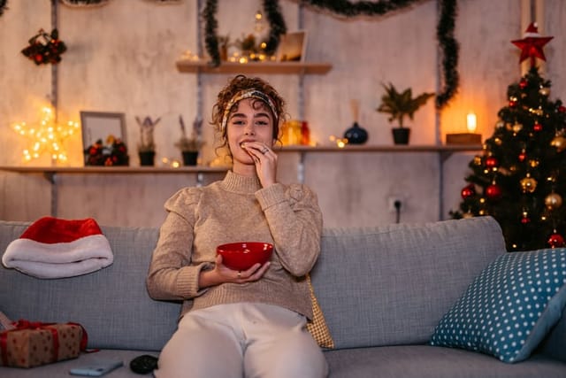 woman watching movies on tv at christmas