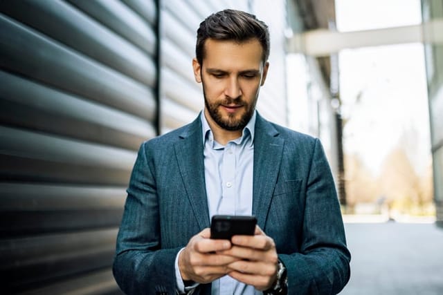 Young businessman using phone
