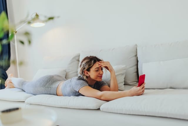 woman chiling on couch on phone