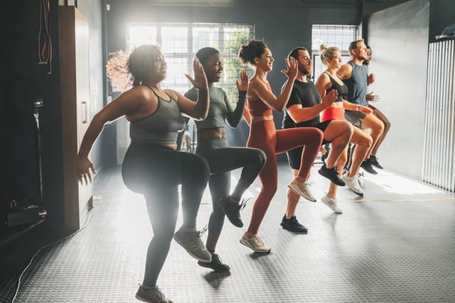 Diversity in gym class doing workout, training and exercise. Multicultural, happy and diverse people with different body shape and size exercising and active at a gym for fitness, wellness and cardio