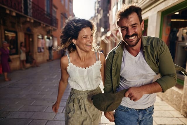 smiling couple walking through city streets