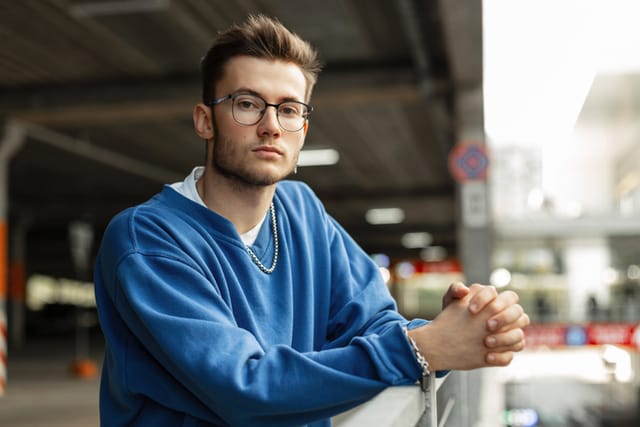 handsome millennial man with hands crossed
