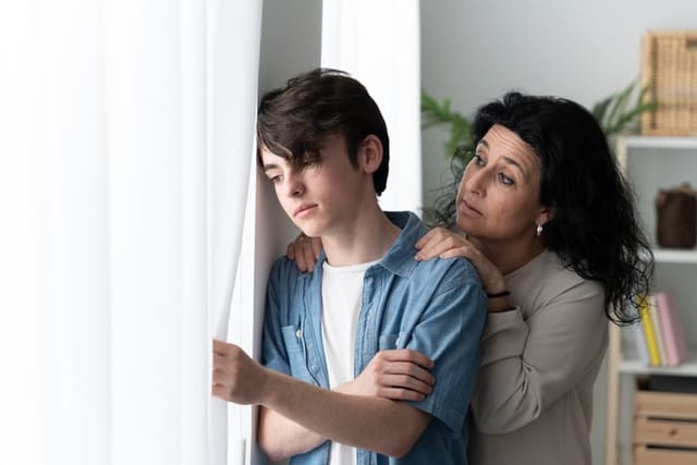 Mother comforting sad teenager son. Depression in adolescence concept