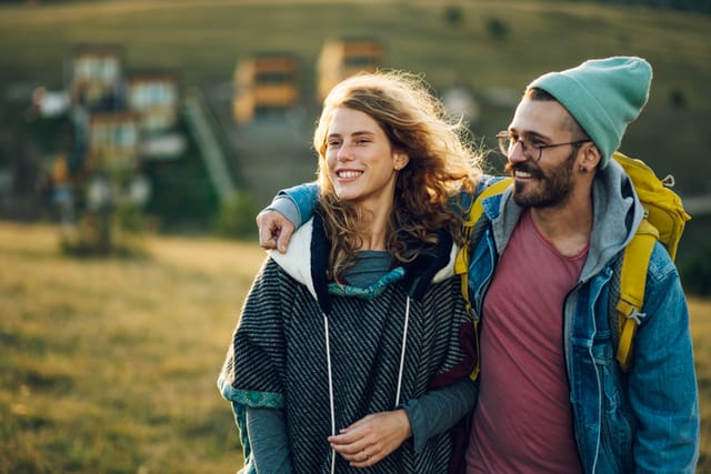 couple on a hike in sunshine