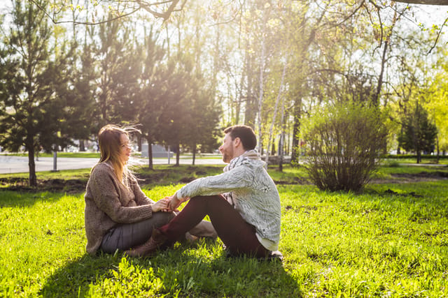 Romantic young couple in love relaxing outdoors in park.