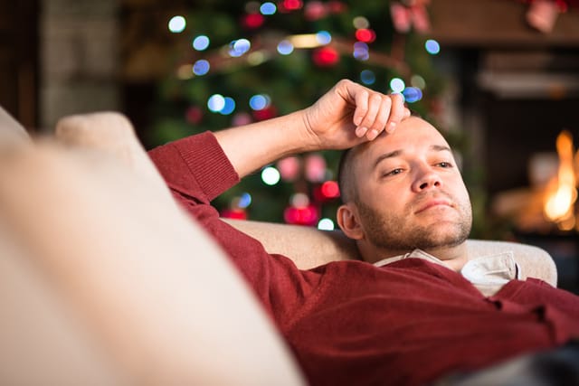 fed up guy on couch at christmas