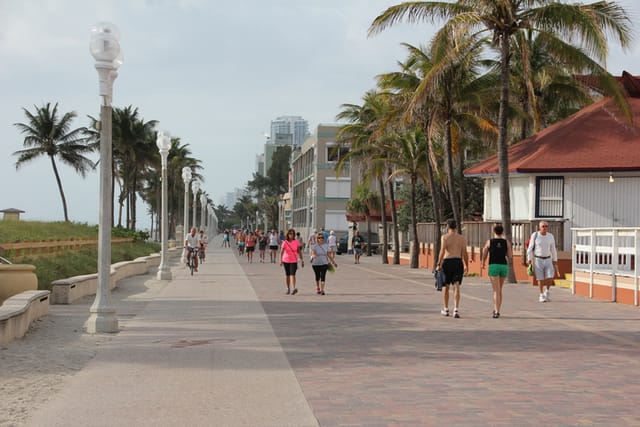 People enjoy walking at the N Broadwalk of Hollywood Beach, Florida, USA.