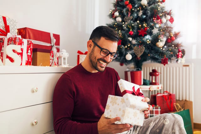 guy opening presents in christmas gift