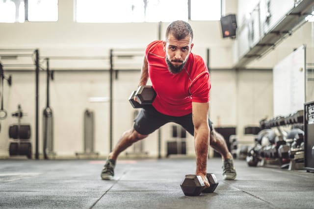Strong man is doing cross training exercise