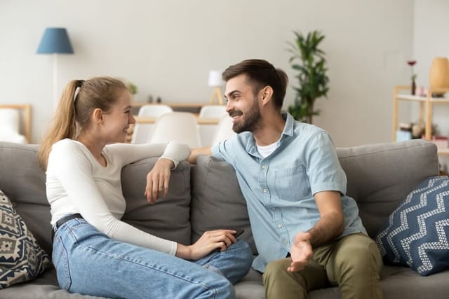 Couple sitting in living room.