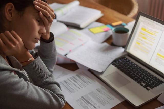 stressed woman overworked at computer