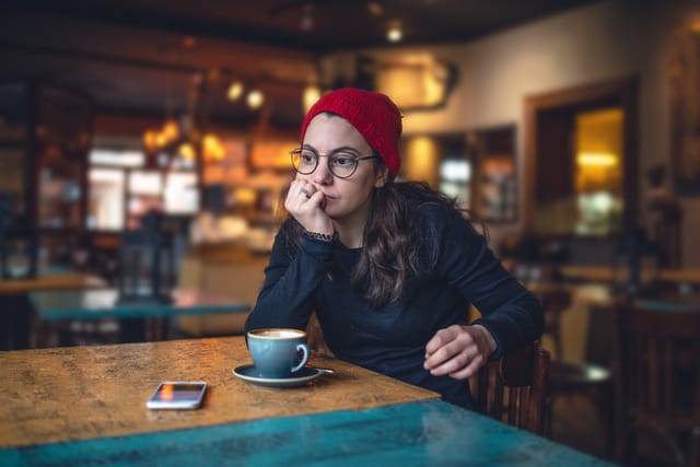 stressed out woman in coffee shop