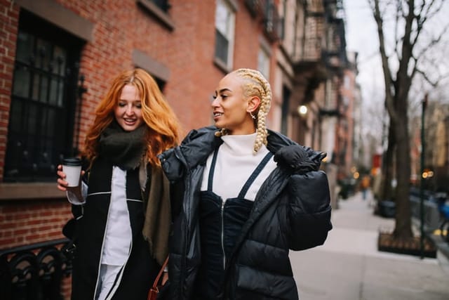 Female friends talking on the street.