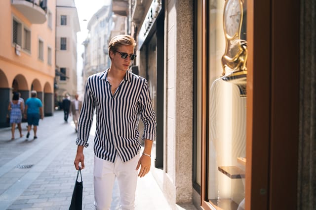stylish man walking through city