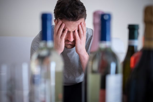 upset man with wine bottles