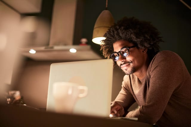 guy working at his laptop at night