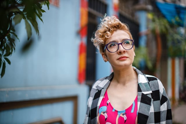 serious hipster woman looking up