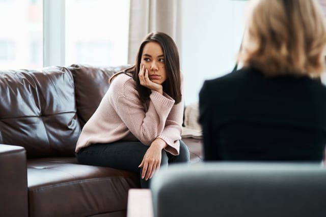 woman looking away from therapist