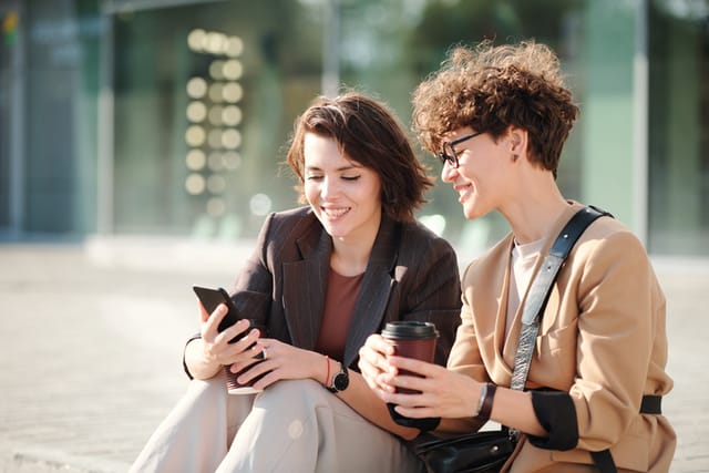 two friends looking at a cell phone