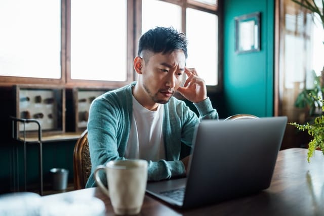 frustrated man sitting at computer