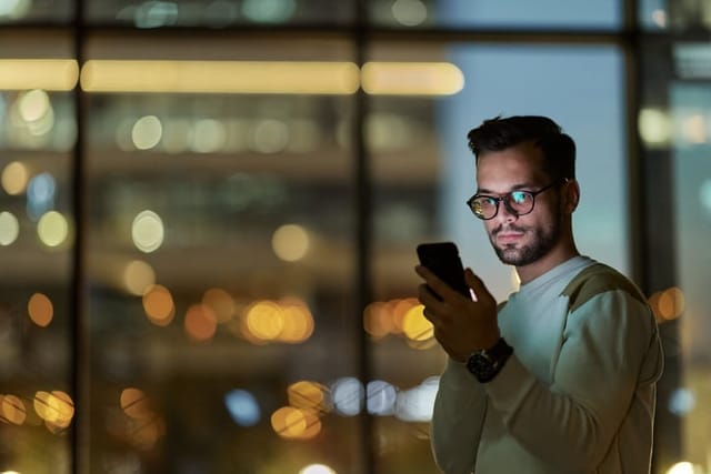 guy texting at night