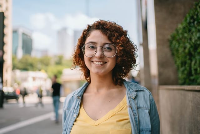 smiling woman with curly hair outside