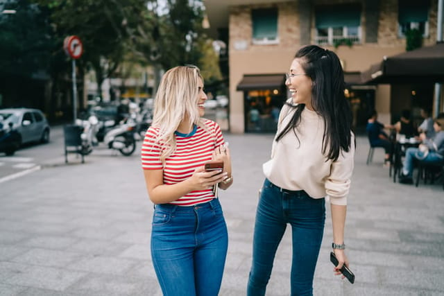 female friends laughing while walking