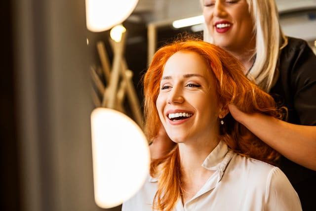 woman with red hair at salon
