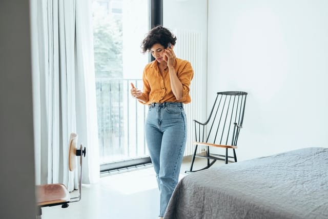woman talking on phone in apartment