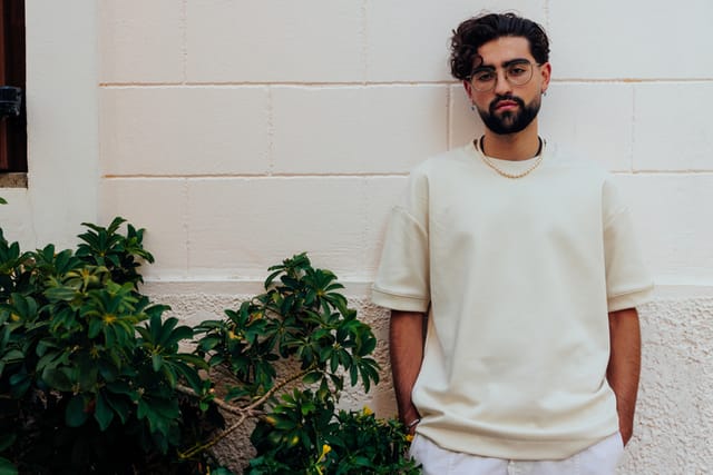 man standing against wall outside