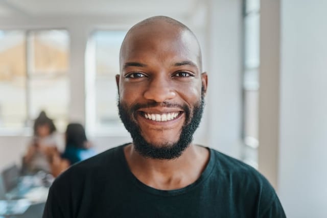 smiling black entrepreneur man in office