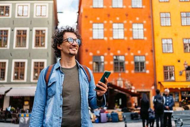smiling man walking through city