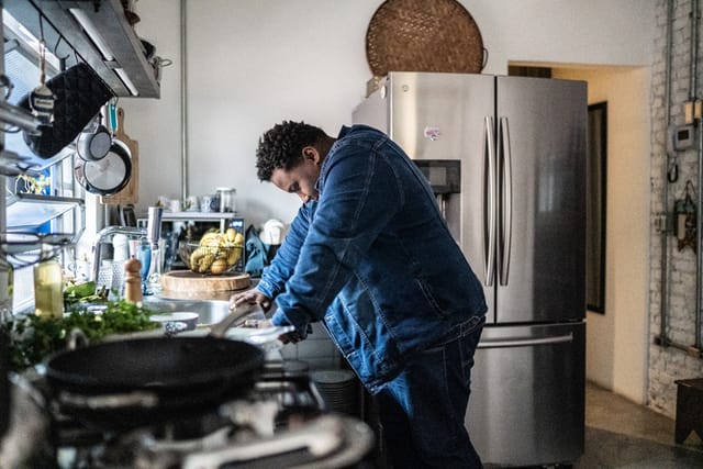 sad man in kitchen looking down