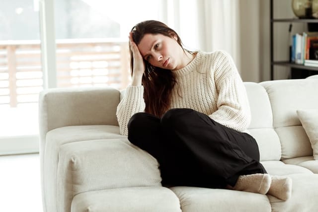 sad woman on couch