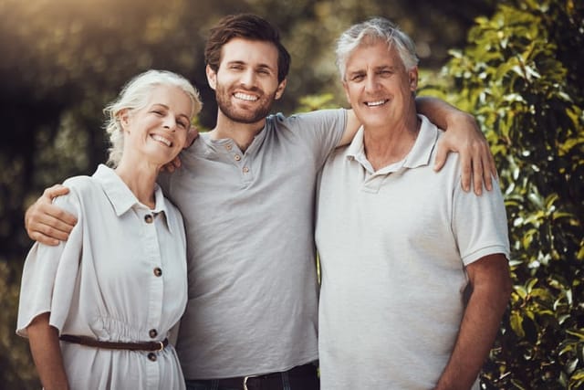 Happy family, portrait or bonding hug and senior parents, mother or father in nature park, home backyard or house garden. Smile, man or retirement elderly in embrace profile picture, love or support