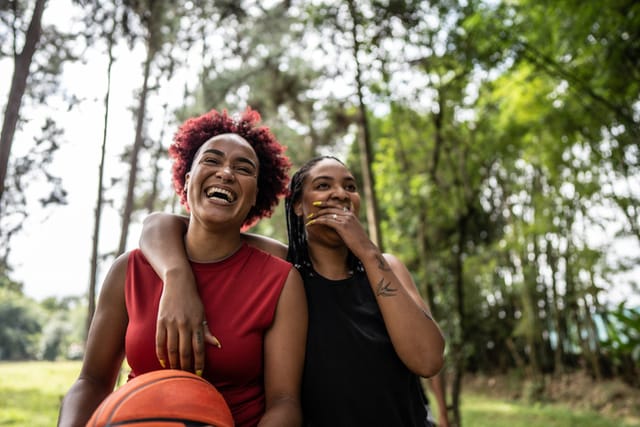 two friends laughing in the park