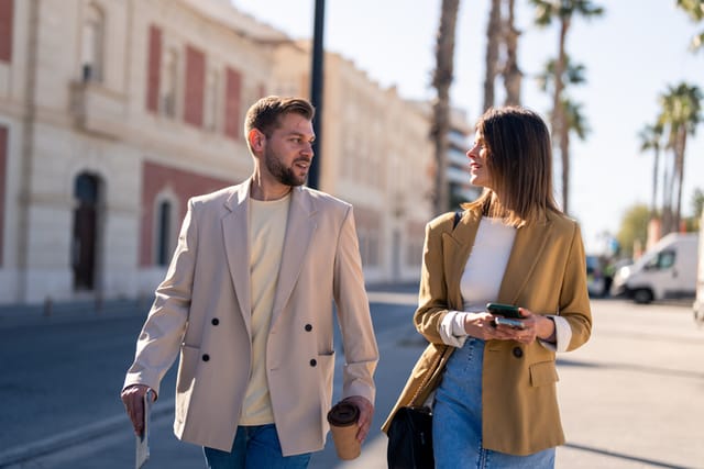 two colleagues walking down the street