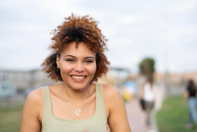 smiling woman standing outside
