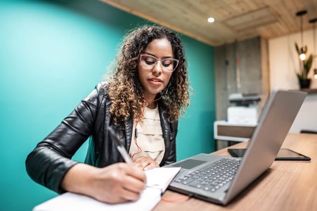 millennial woman working at laptop