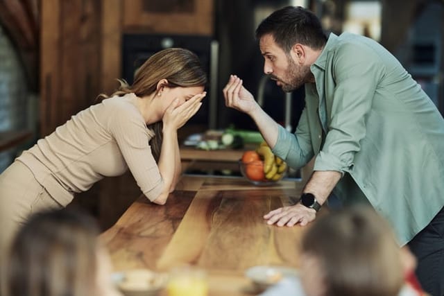 adult couple in an argument in kitchen