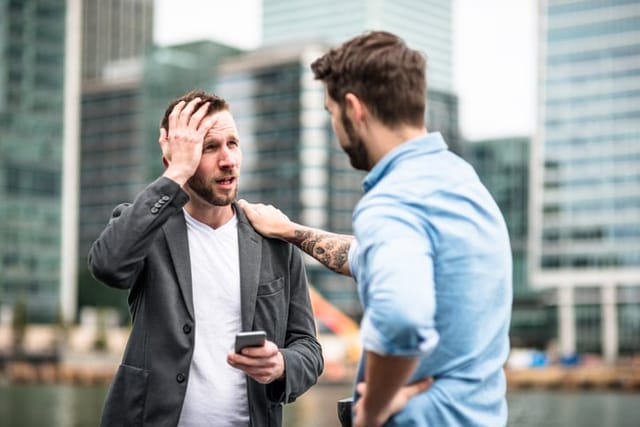 two men arguing in public