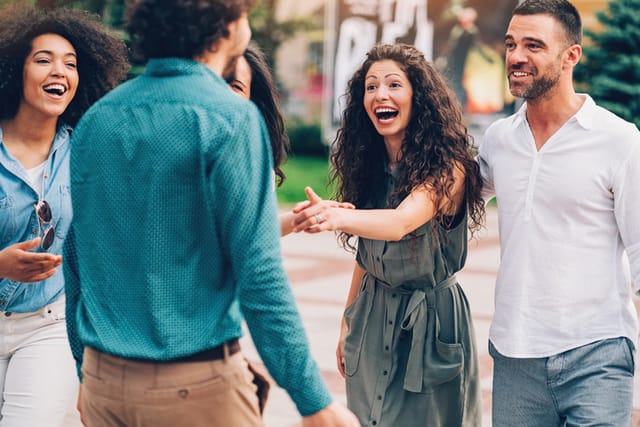 woman laughing at her friend group