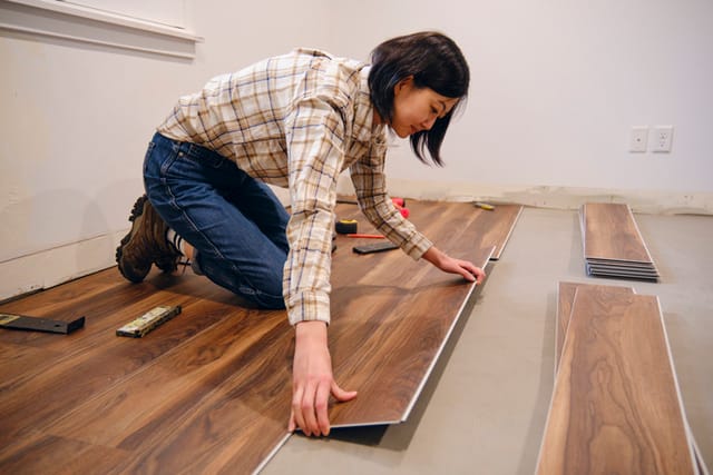 woman doing DIY laying floor