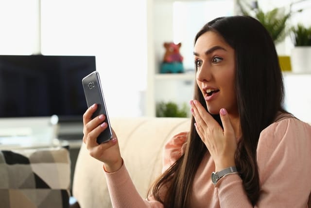surprised woman looking at phone
